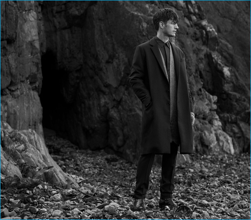 Axel Hermann wears cardigan J.W. Anderson, slim tailored trousers Lanvin, suede ankle boots Paul Smith, double-breasted coat and shirt Marni.