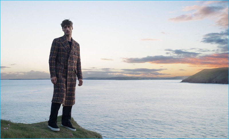 Axel Hermann wears cashmere sweater Brioni, sneakers Eytys, double-breasted tweed plaid coat and wool flannel trousers Bottega Veneta.