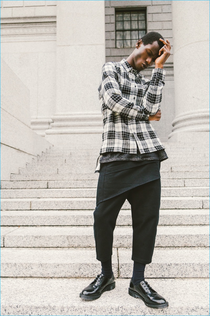 Sporting a plaid shirt and paneled cropped pants, Adonis Bosso layers in fall fashions from Matiere. 