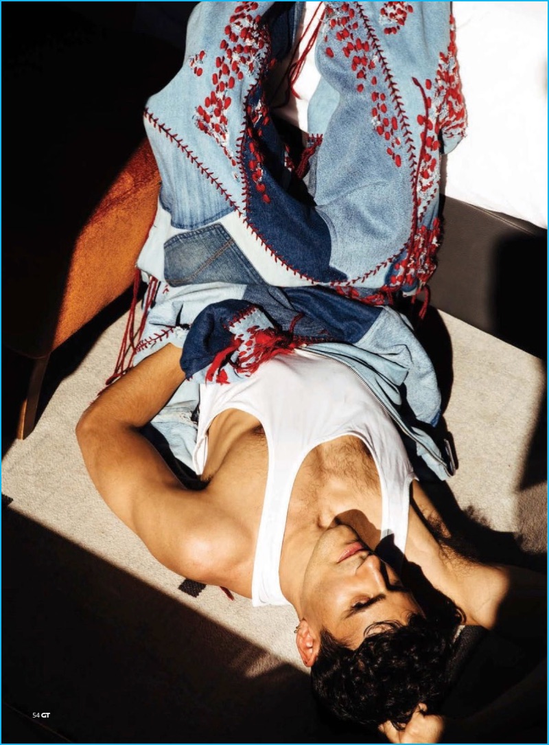 Neil Amin-Smith pictured in a denim jumpsuit from Bethany Williams for Gay Times.