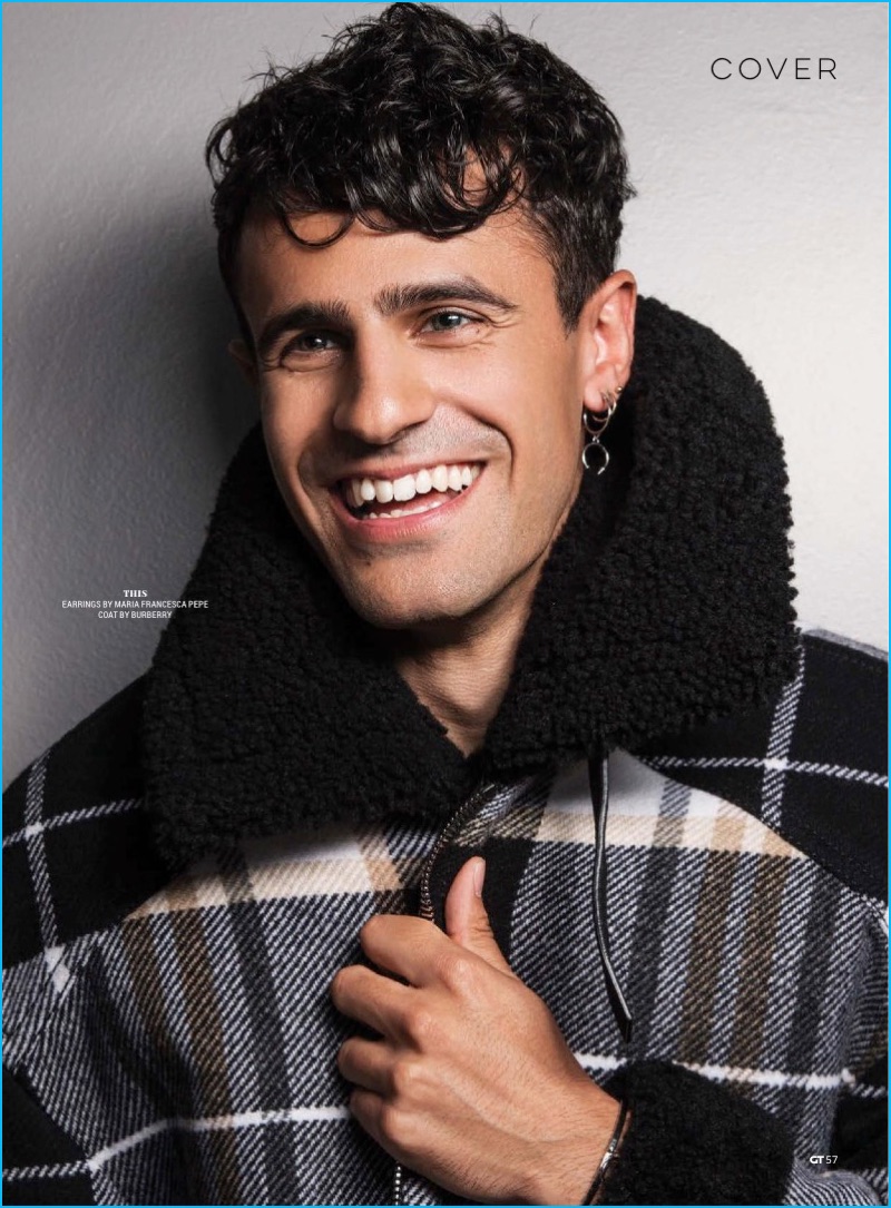 Neil Amin-Smith is all smiles in a check Burberry jacket for Gay Times.