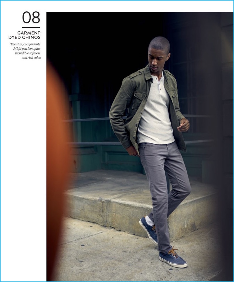 Garment-Dyed Chinos: Claudio Monteiro is a man out on the town, wearing AG slim-fit chinos and a long sleeve henley with a military style shirt jacket and Sperry sneakers.