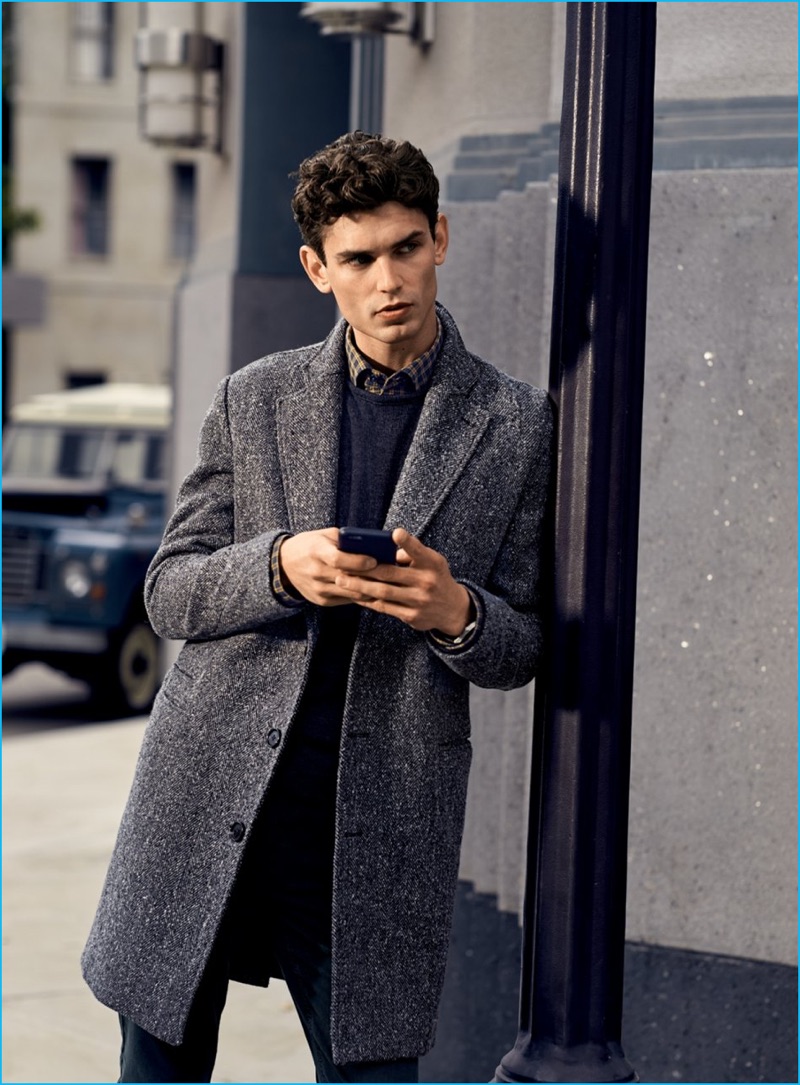 Arthur Gosse wears herringbone coat, sweater, plaid shirt, and corduroy pants Billy Reid.