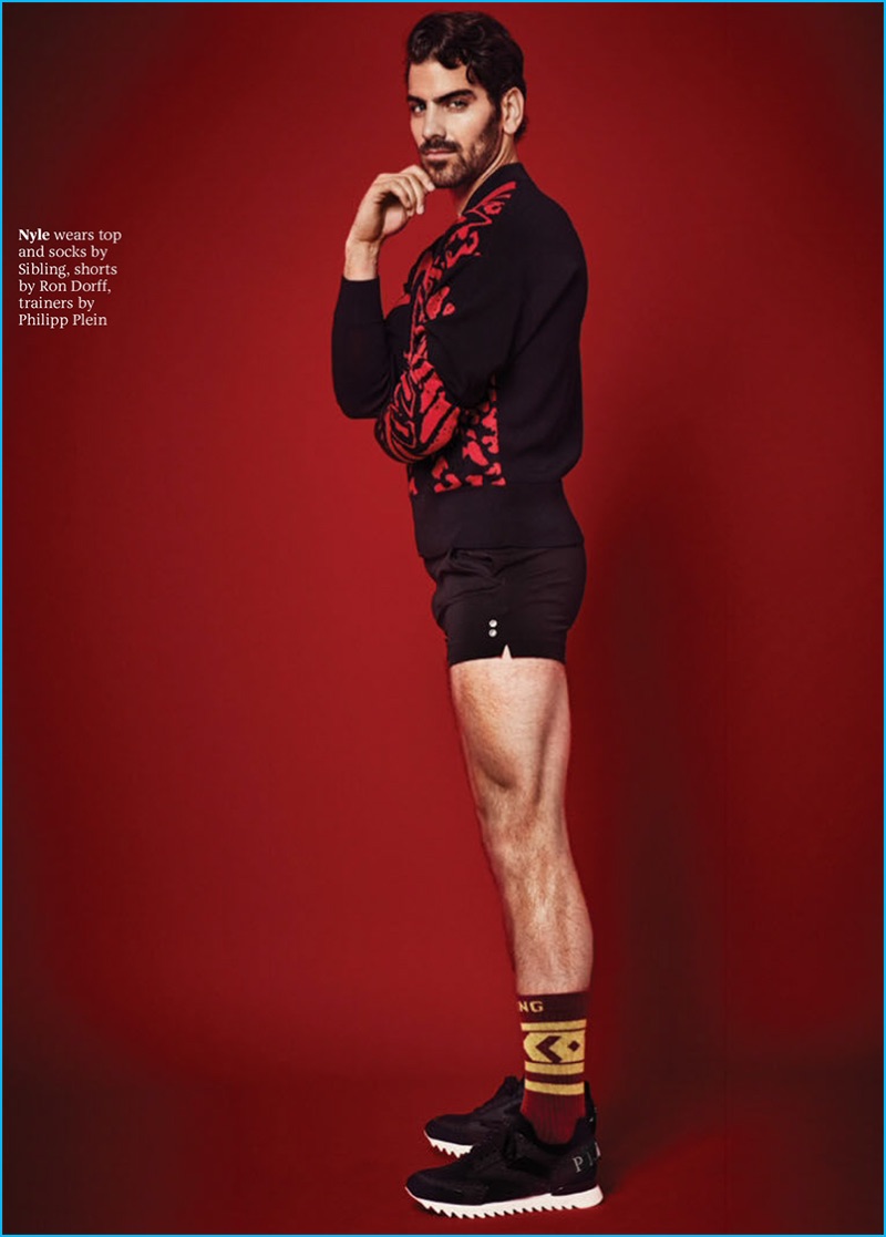 Nyle DiMarco sports a sweater and socks from Sibling with Ron Dorff shorts and Philipp Plein sneakers.