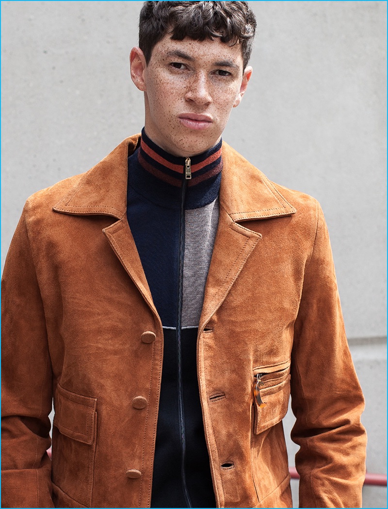 Jos Whiteman wears paneled wool cardigan and suede jacket CMMN SWDN.