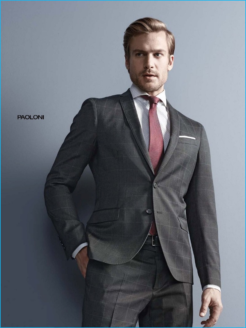Jason Morgan dons a windowpane print grey suit from Paoloini. 