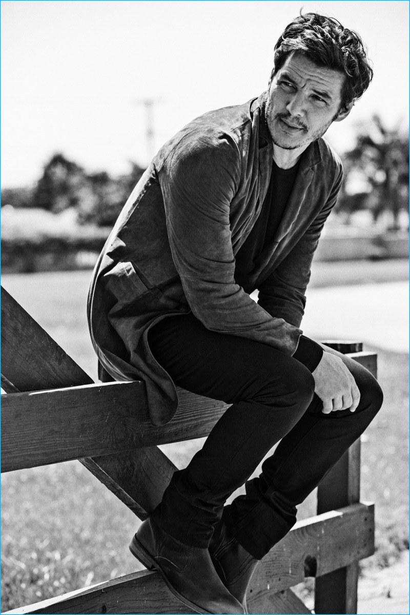 Pedro Pascal relaxes in a John Varvatos jacket and boots with an A.P.C. sweater and trousers. 