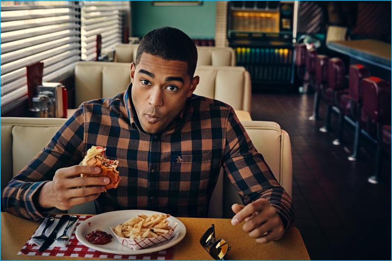 Sporting a check shirt, Shayne Cureton enjoys a cheeseburger for Original Penguin's fall-winter 2016 campaign.