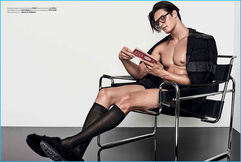 Matthew Terry relaxes in a Fendi tweed jacket, paired with La Perla underwear, Dolce & Gabbana shearling loafers, and black framed Tom Ford glasses.