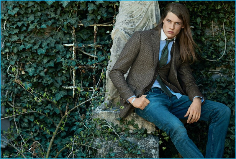 James Phillips models a waistcoat and sport coat with denim jeans for Polo Ralph Lauren's fall-winter 2016 campaign.