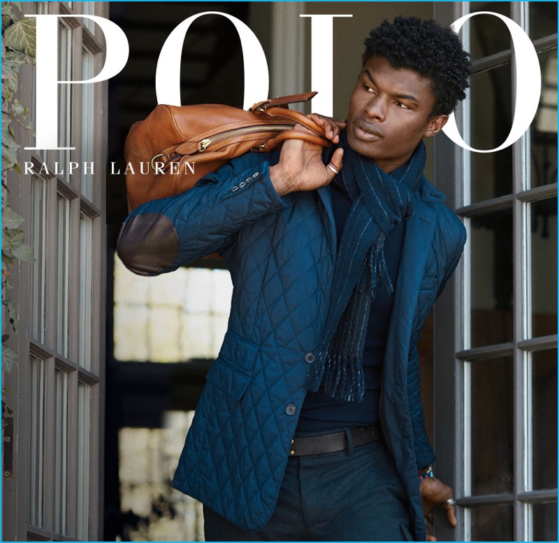 Salieu Jalloh enjoys a casual but chic moment in a blue quilted jacket with patch elbows for Polo Ralph Lauren's fall-winter 2016 campaign.