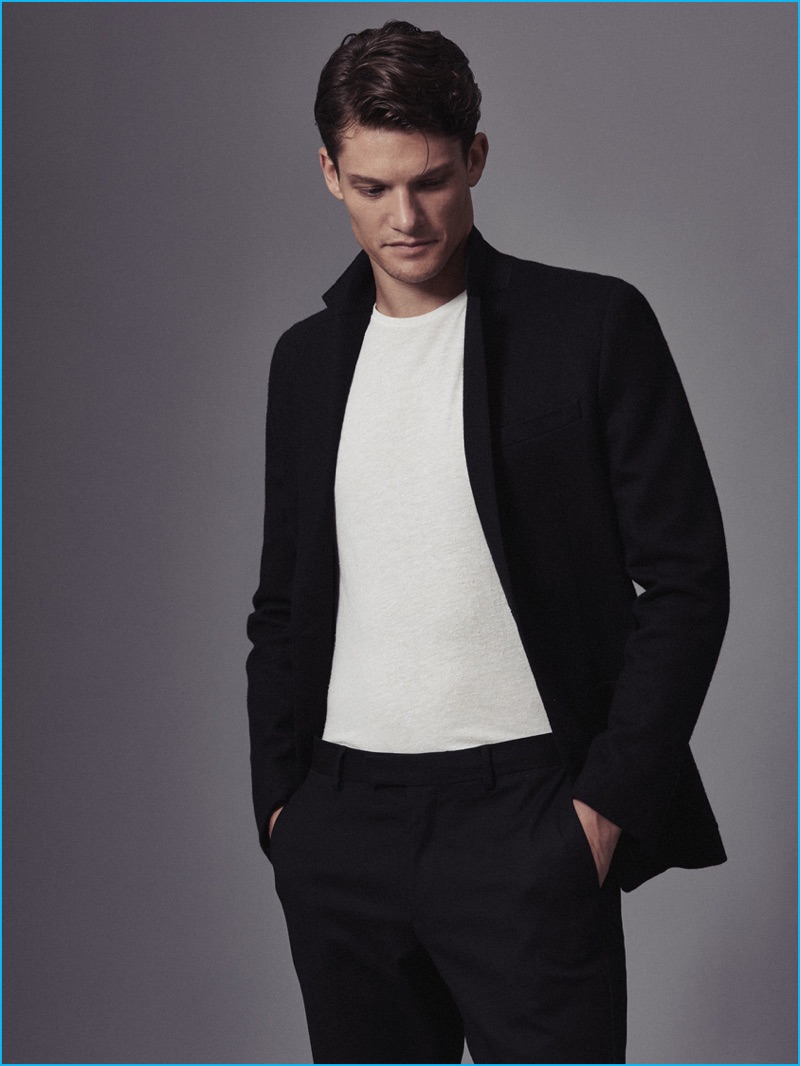 Danny Beauchamp goes semi-casual with a suit and crewneck t-shirt from Reiss.