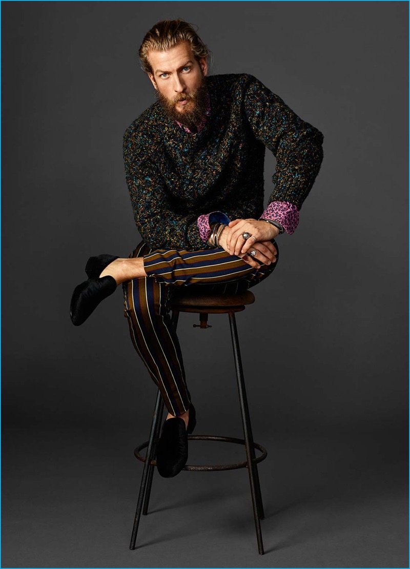 Scotch & Soda stands by emerald hues with a cable pattern sweater, striped tailored trousers, and printed shirt.