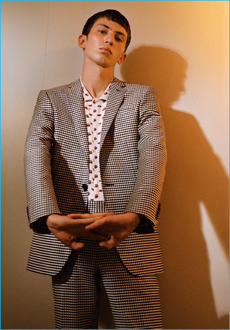 The essential check suit is front and center with a trim spin from Bally. Mixing prints, the suit is styled with the label's lip print silk shirt.