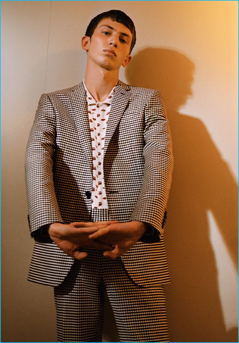 The essential check suit is front and center with a trim spin from Bally. Mixing prints, the suit is styled with the label's lip print silk shirt.