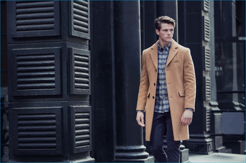 Alex Valley dons a single-breasted camel coat for Slate & Stone's fall-winter 2016 campaign.
