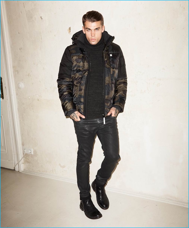 Stephen James rocks a camouflage G-Star Raw jacket with coated jeans for Theo Wormland's fall-winter 2016 campaign.