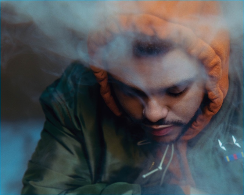 The Weeknd pictured in a Burberry bomber jacket and Mr. Completely hoodie for VMAN.