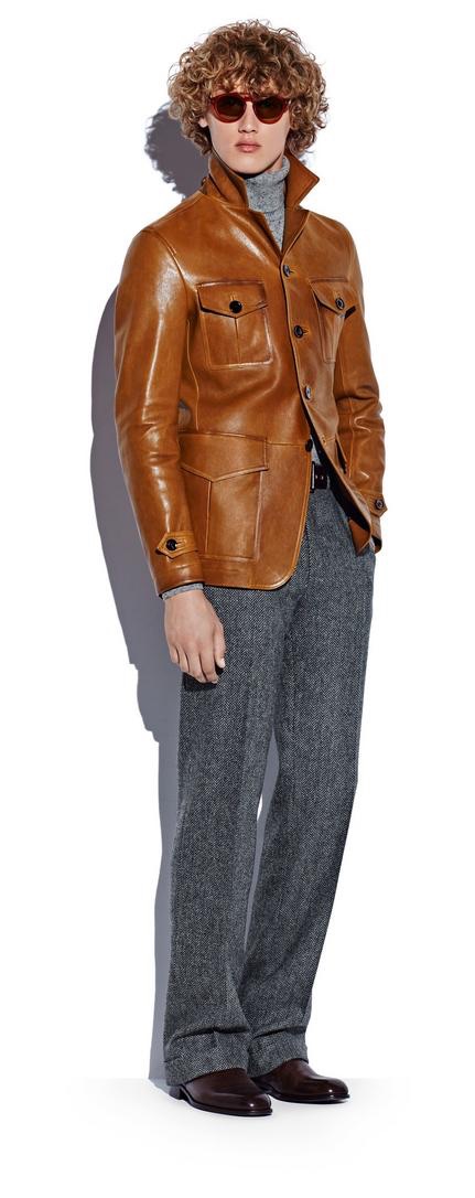 Bram Valbracht dons a brown leather military jacket, turtleneck sweater, and grey soft tweed trousers from Tom Ford's fall-winter 2016 men's collection.