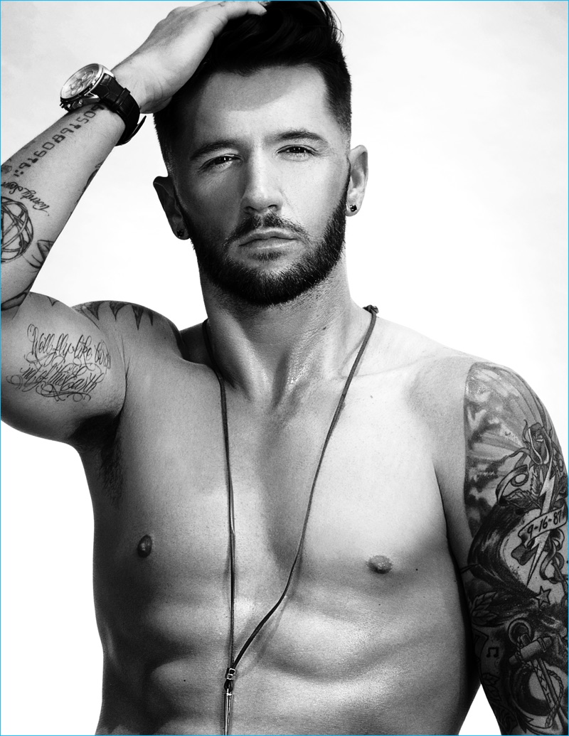 Travis Wall goes shirtless for his Ferrvor photo shoot, wearing a H&M necklace and Hugo Boss watch.
