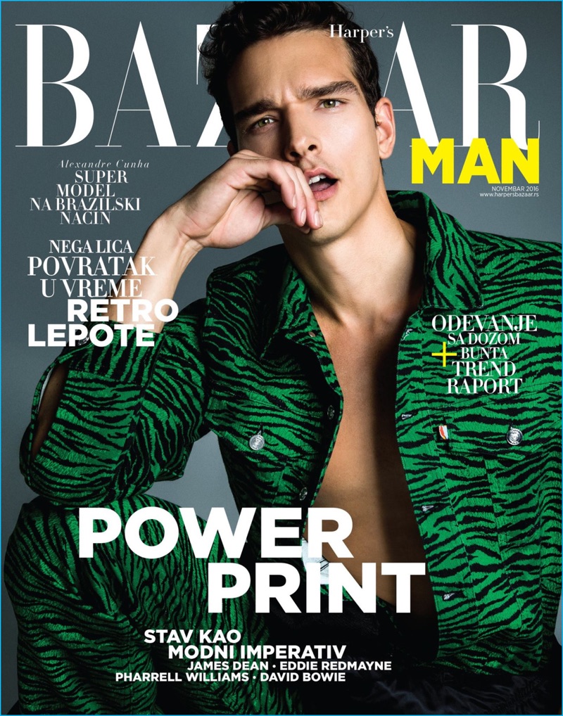 Alexandre Cunha covers Harper's Bazaar Man Serbia in a green tiger print jumpsuit from Kenzo's H&M collaboration.