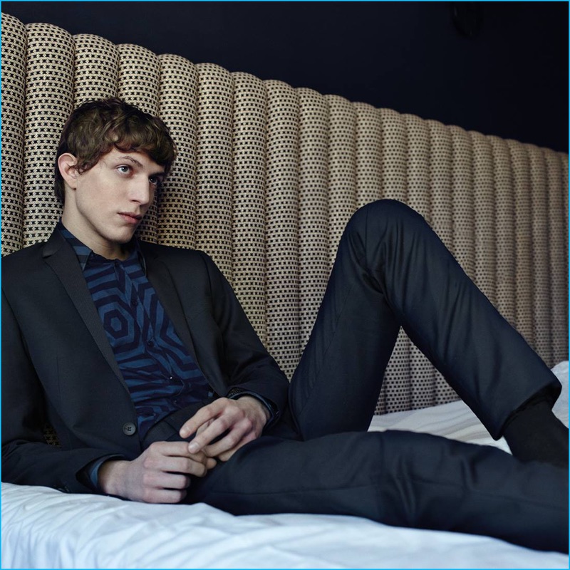Relaxing in bed, Xavier Buestel dons a trim suit for Antony Morato's fall-winter 2016 campaign.