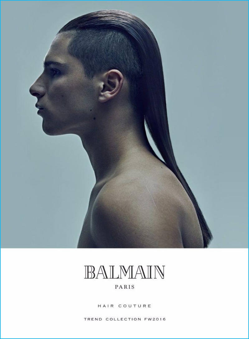 Model Christopher Hinchey shows off his long hairstyle with shaven sides for Balmain's fall-winter 2016 hair trends book. 