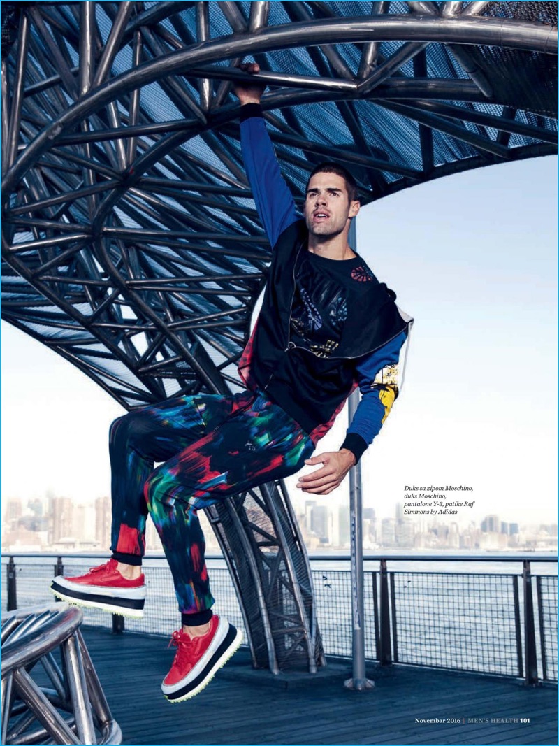 Taking to Brooklyn, Chad White wears Y-3 pants and Raf Simons x Adidas sneakers with a graphic t-shirt and hooded jacket from Moschino.