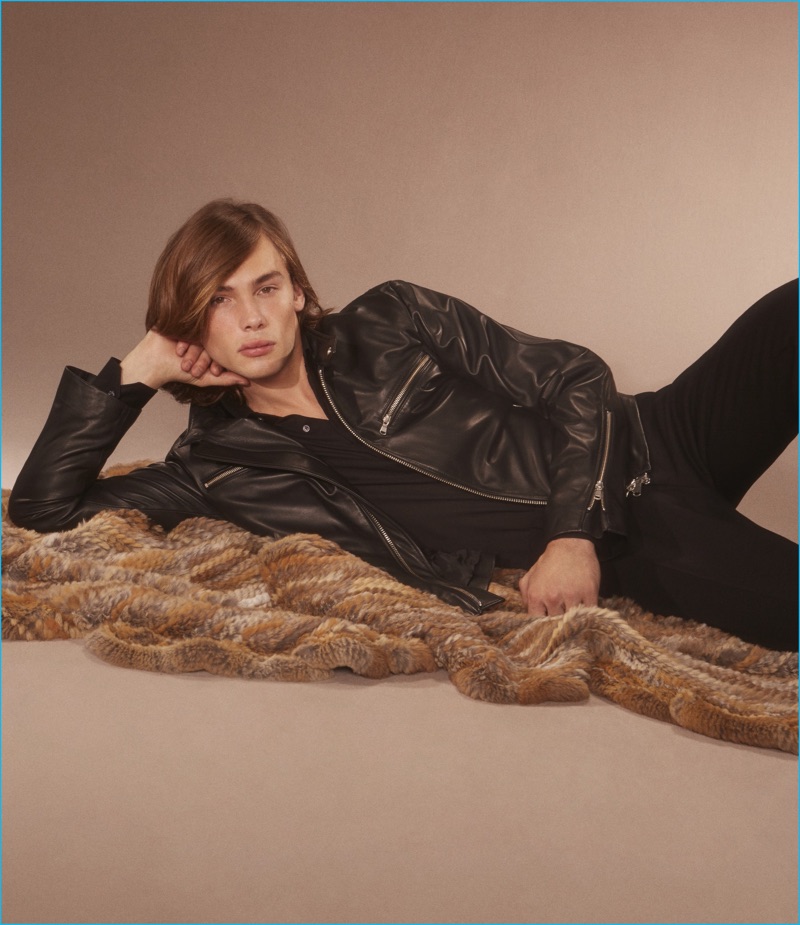 Anders Donatelli lounges in a leather zip-front jacket, long sleeve polo shirt, and wool trousers from Cifonelli.