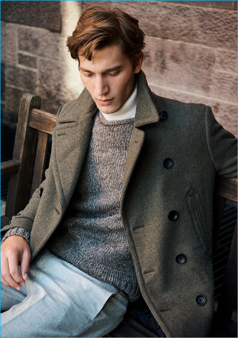 Model Jeff Ryan takes on subtle military style in Club Monaco's lieutenant coat, cashmere turtleneck, alpaca wool sweater, and melange dress trousers.