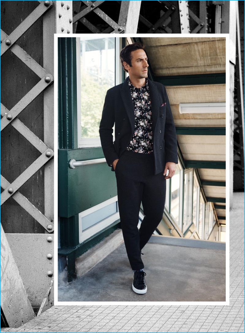 Model Josh Wald is front and center in a double-breasted knit blazer, slim floral shirt, and raw edge wool pants from Club Monaco.