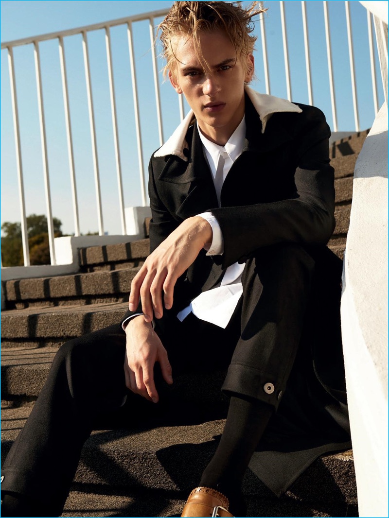 Dominik Sadoch dons a Prada coat for the latest issue of Elle Man Poland.