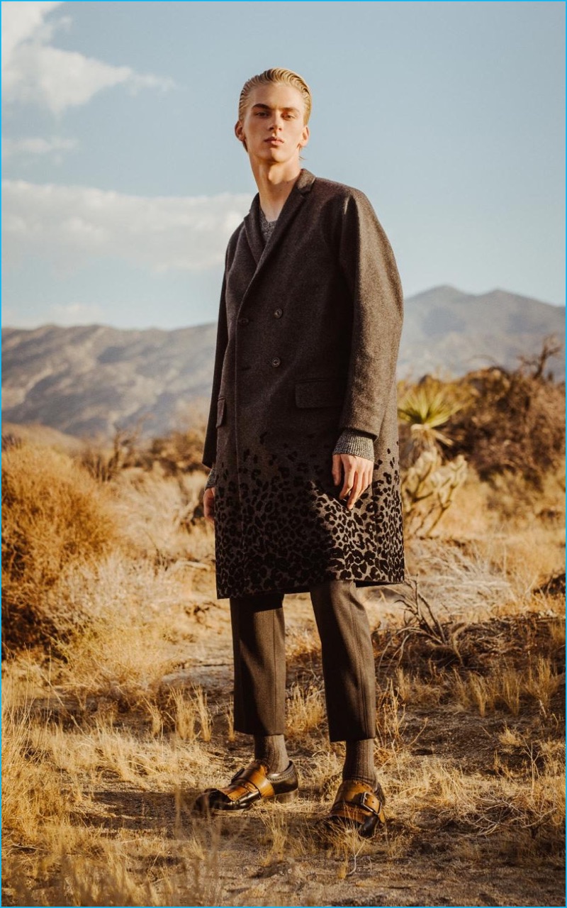 Jason Hughes outfits Dominik Sadoch in a leopard print coat from Kolor with Prada leather shoes, a Dunhill sweater and wool trousers.