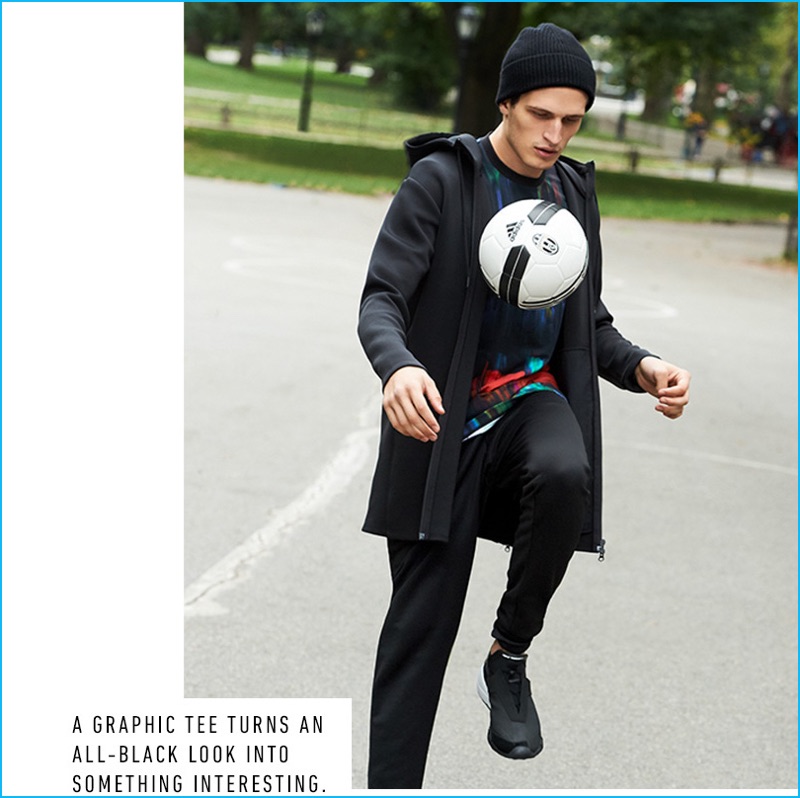Kicking a soccer ball, Kimi Halili sports Y-3's spacer jacket, all over print jersey tee, classic track pants, and future low sneakers. Kimi's look is finished with a Braun classic chronograph watch and cashmere beanie from Rag & Bone.