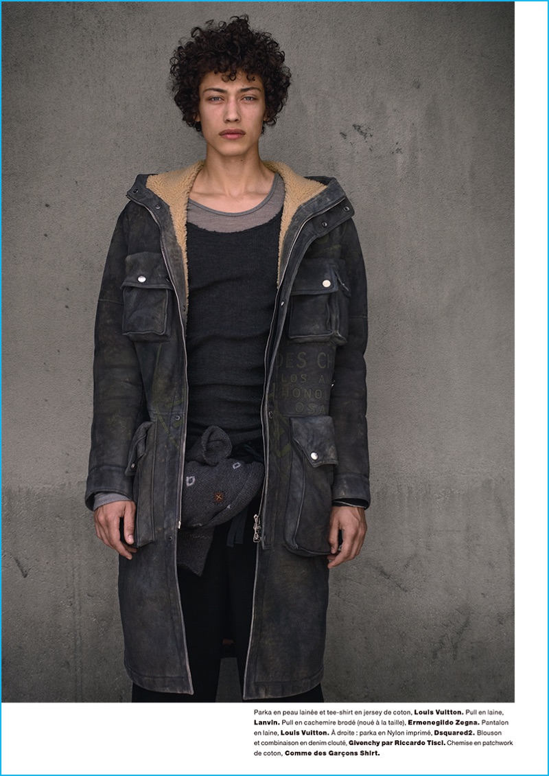 Max Fieschi is front and center in a Louis Vuitton parka and Lanvin knit. The model also wears Louis Vuitton pants and an Ermenegildo Zegna sweater tied around his waist.