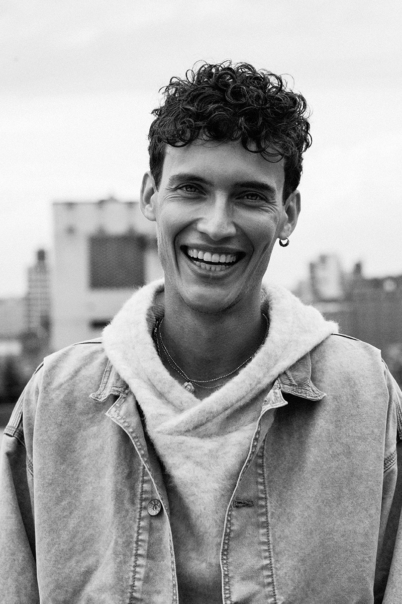 All smiles, Dzhovani Gospodinov wears a Matiere sweatshirt with a UO denim jacket.