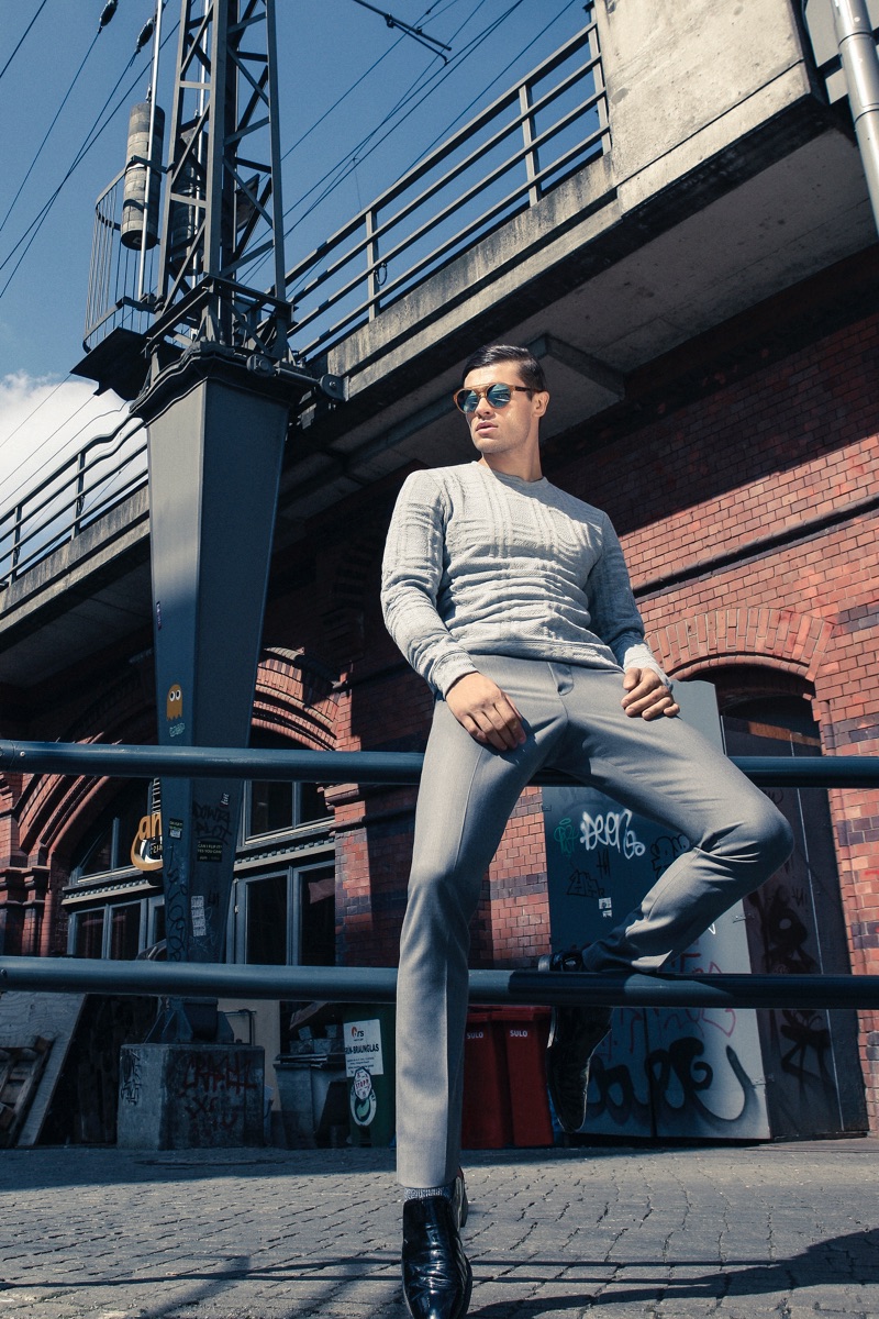 Eugen wears sunglasses IC! Berlin, sweater Kiomi, trousers Ivanman, and shoes J Fenestrier.