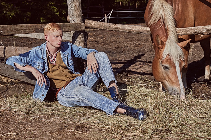 Oliver wears denim jacket Levi's, vintage jeans stylist's own, boots Dr Martens, shirt ASOS, and vest Antifactory Vintage Shop.