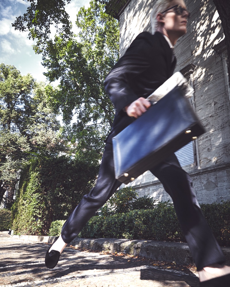 On the move, Stephen Thompson wears a Commes de Garçon suit with an Ermenegildo Zegna shirt, Lanvin tie, Hermes shoes, a Coverlet briefcase, and Moscot sunglasses.