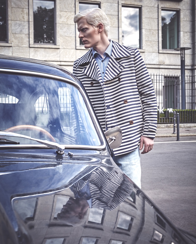 Stephen Thompson sports a Jil Sander shirt, striped Zara peacoat, and David Beckham for H&M Modern Essentials denim jeans.