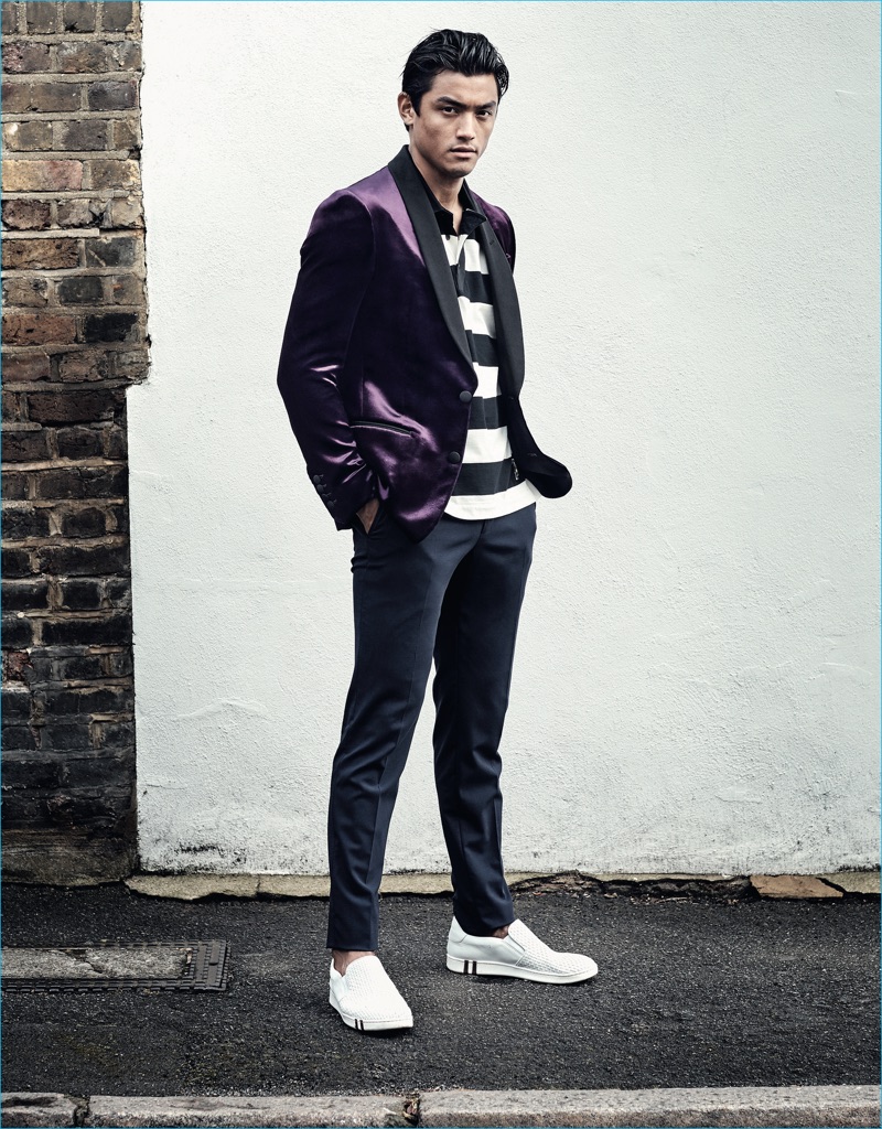 Luiz Piva models a purple velvet blazer and striped polo shirt from Bally for GQ France.