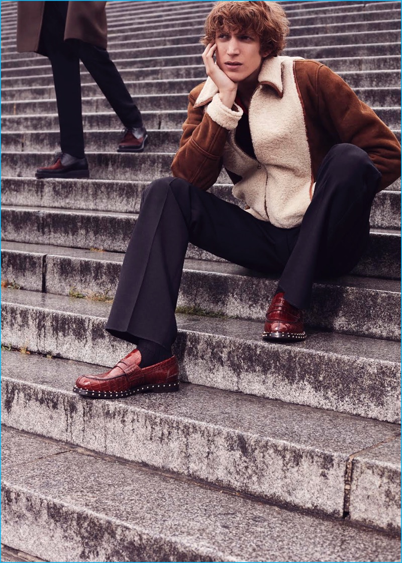 Showcasing fall's shearling trend, Xavier Buestel wears a Corneliani jacket with a polo and pleated trousers from Coach. Xavier also sports Valentino studded loafers.