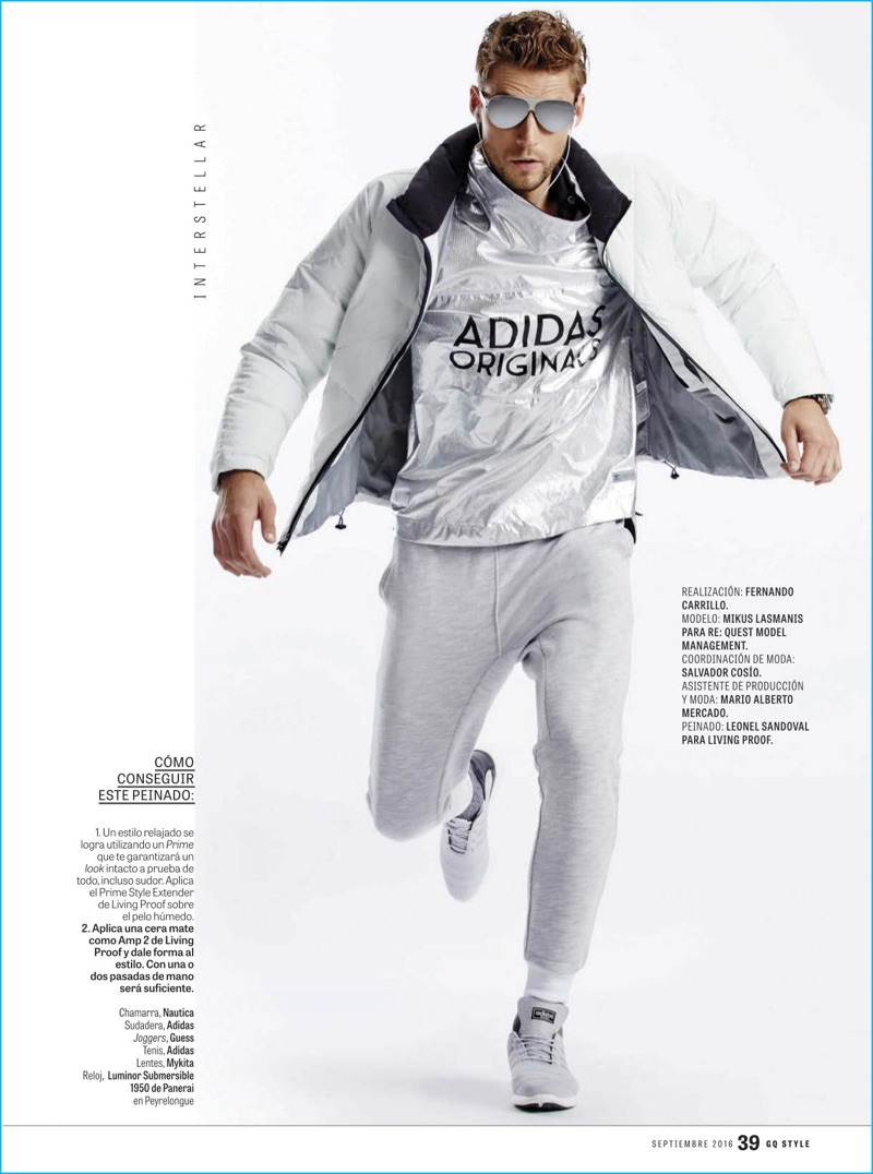 Sporty style is front and center with Mikus Lasmanis donning a Nautica down jacket and Adidas pullover. Fernando Carrillo outfits Mikus in GUESS joggers and Adidas sneakers as well.