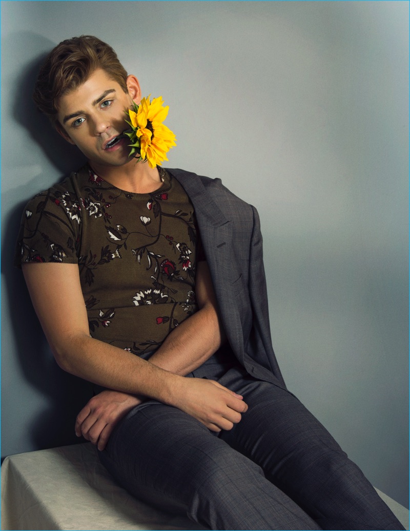 Donning a floral print sweater from Zara, Garrett Clayton sports a check Gucci suit.