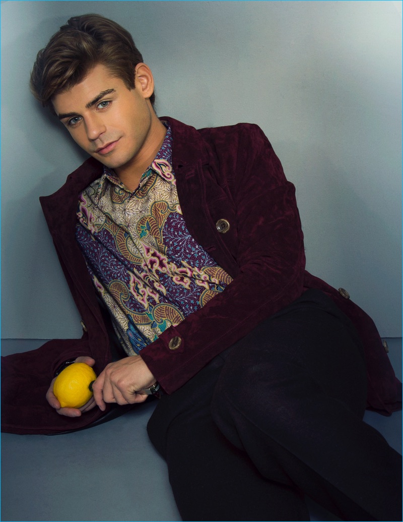 Actor Garrett Clayton sports a Khan Designs trench coat with a Kenzo shirt and Prada trousers.