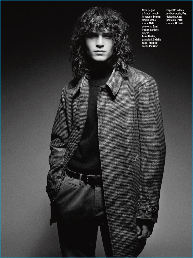 Luca Roscini outfits George Culafic in a Fay houndstooth coat, COS turtleneck , PTOI trousers, and Orciani leather belt.