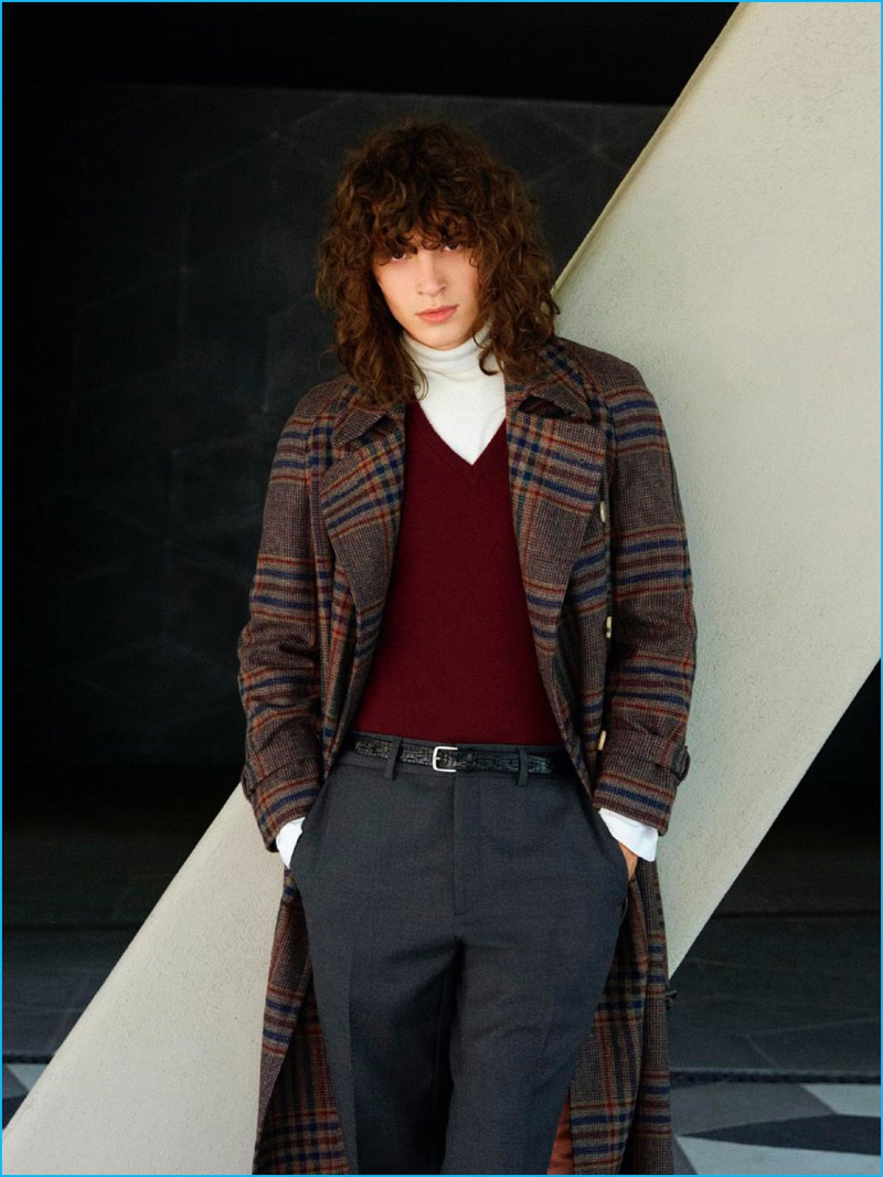 Going preppy, George Culafic wears a check Gucci coat, Malo v-neck sweater, Lardini turtleneck, and Fendi trousers with an Orciani leather belt.