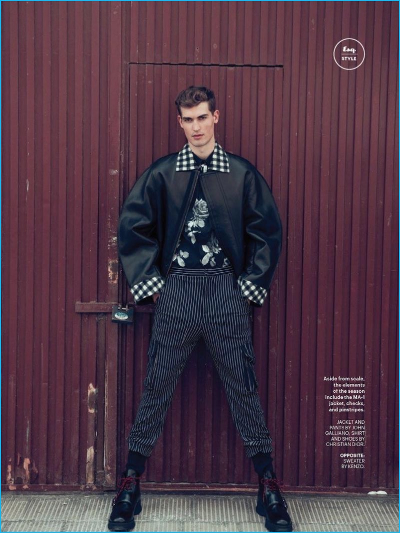 Wearing a black fall outfit, Jason Anthony is front and center in a jacket and striped pants from John Galliano with a shirt and boots from Dior Homme.