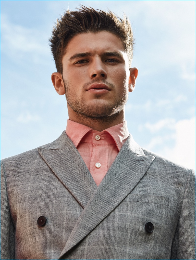 Jevan Williams dons a double-breasted jacket from Reiss for Winq.