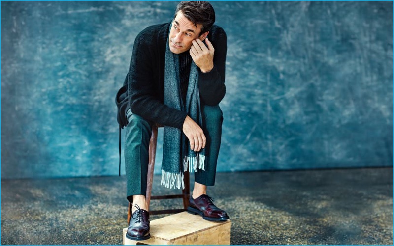 Connecting with Mr Porter, Jon Hamm wears a Berluti belted cashmere cardigan and textured turtleneck sweater with Canali wool trousers, John Lobb oxford shoes, and a Tom Ford herringbone cashmere scarf.